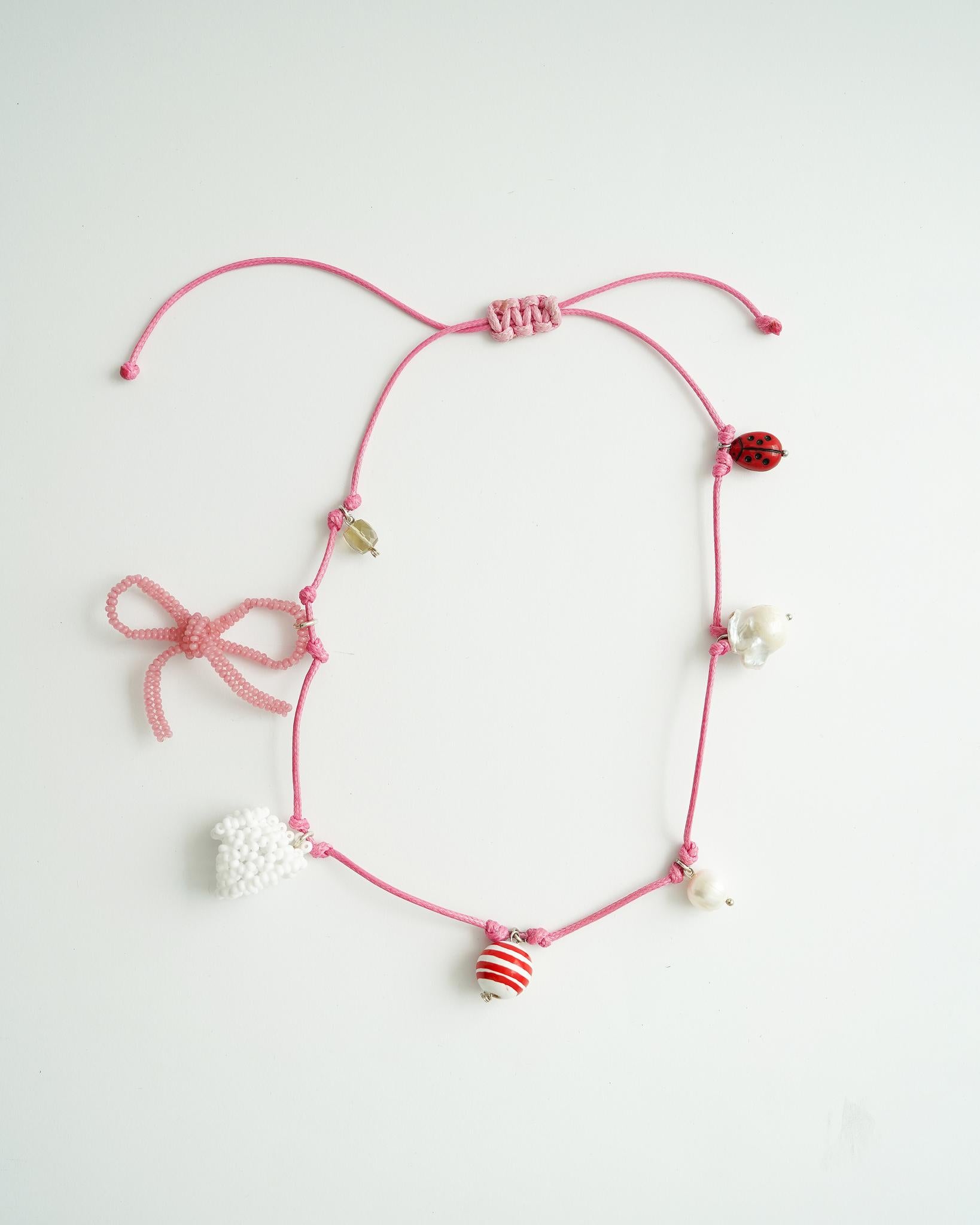 Mikita Kunitsky - Pink Thread with Charms